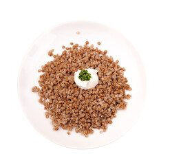 Dieting buckwheat porridge with sour cream on a plate