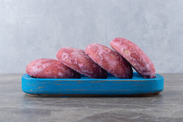Pink cookies on a platter on marble background