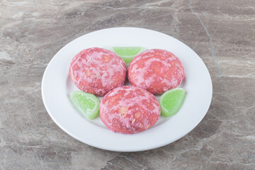 Marmelades and cookies on a platter on marble background