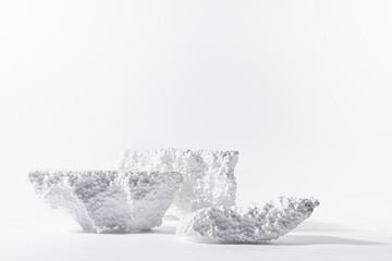 Styrofoam podiums for presentation cosmetic products or goods as elegant white icebergs in hard light with shadows in elegant grunge modern style. Template stage for advertising and design.