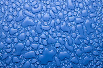 Water drops on bright fresh blue background as colorful pattern with glossy droplets and gradient,...