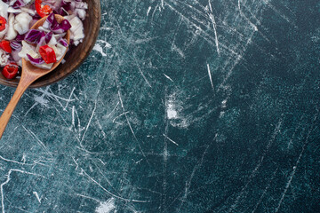 Salad with chopped purple cabbage, cauliflower and herbs