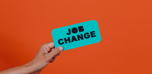 holds a sign with the text job change