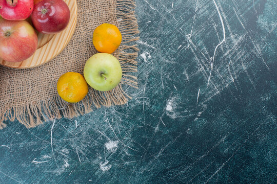 Autumn fruits in a platter on blue background