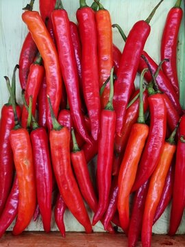 Red hot chilli peppers pattern texture background. Close up. put on a wooden tray for sale in a fodd supermarket in Thailand.