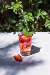 a strawberry cocktail on a white table. Drinks and summer concept.