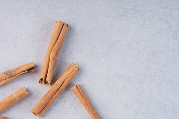 Cinnamon sticks isolated on concrete background