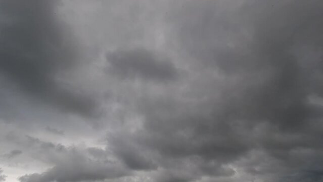 Timelapse shot of grey clouds rolling through the sky 