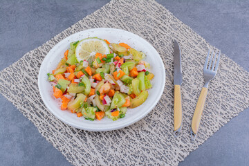 Salad with seasonal herbs and vegetables in a platter