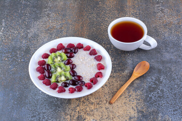 Milky porridge with berries and a cup of tea