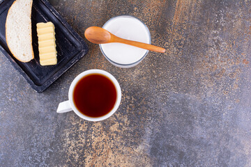 Breakfast board with bread and a cup of tea