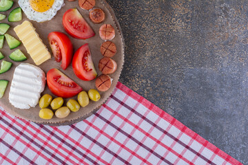 Breakfast board with fried egg and vegetable salad