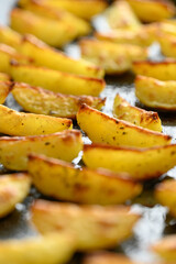homemade potato wedges on a baking sheet