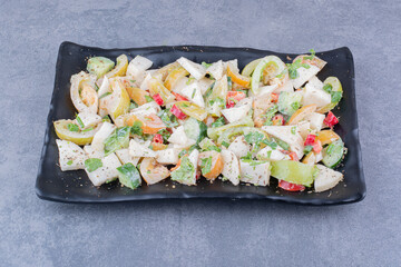 Green seasonal salad with minced and chopped vegetable in a platter