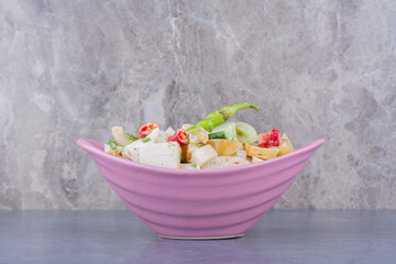 Green seasonal salad with minced and chopped vegetable in a platter
