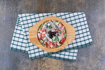Vegetable salad with herbs and red tomatoes in a plate
