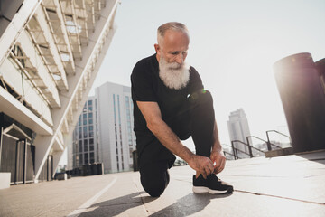 Photo of bearded focused dedicated man fix shoelace prepare run long sprint wear t-shirt urban town...
