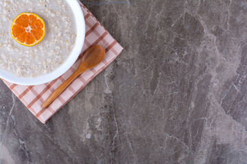 Milky porridge with an orange slice on the top