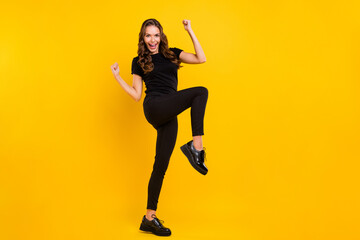 Fototapeta na wymiar Full body profile side photo of young cheerful girl rejoice victory fists hands triumph success isolated over yellow color background