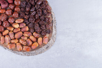 Variety of dry fruits on a wooden platter