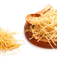 Uncooked pasta in the wooden spoon on the white background