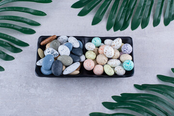 Multicolor decorative stones isolated on concrete background