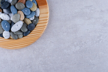 Fototapeta na wymiar Multicolor decorative stones isolated on concrete background