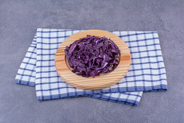 Chopped purple cabbage on a wooden platter