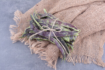 Green beans isolated on concrete background