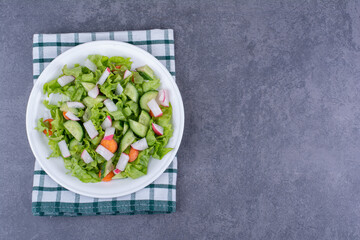 Green salad in a plate with mixed ingredients