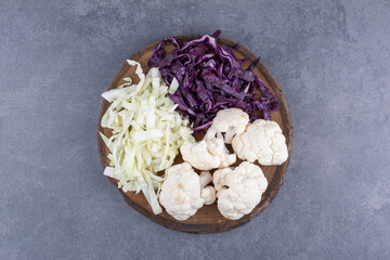 Chopped and minced cabbage on a wooden platter