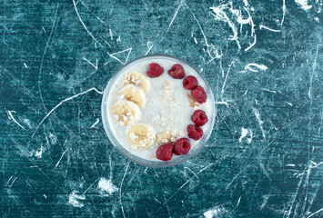 Milky smoothie with fruits and berries on the top