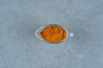 Blended curcumin powder in a glass cup