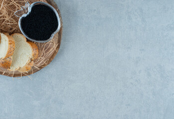 Molasses syrup with bread slices on a wooden board