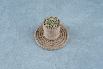 Fototapeta na wymiar Dried green anise seeds in a wooden cup