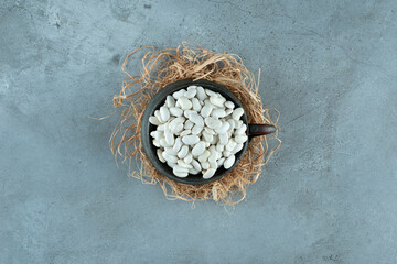 White beans in a black metallic pot