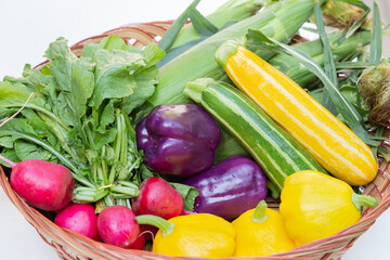 A basket of freshly picked vegetables from a local farmer's market.