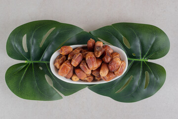 Yellow dry dates in a ceramic bowl