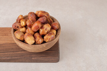 Yellow dry dates on a wooden platter