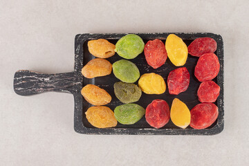 Dry colorful cherries on a wooden platter