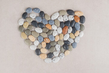 Multicolor beach stones isolated on concrete background