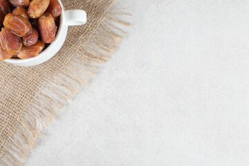 Yellow dry dates in a ceramic dish