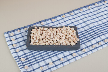 Pea beans in a food tray on concrete background