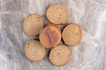 Bundled slices of black bread on marble background