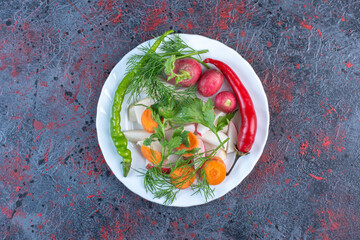 Vegetable mix on a white platter on dark colored background