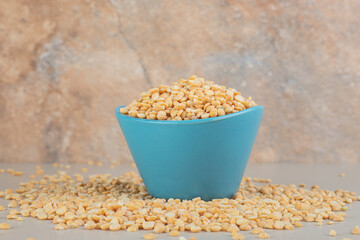 Yellow pea beans in a blue ceramic cup