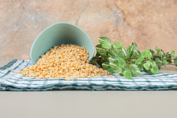 Yellow pea beans in a ceramic cup or bowl on concrete background
