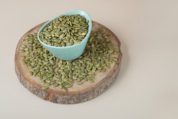 Green pumpkin seeds isolated on concrete background
