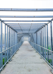 The unique interior of the over bridge. Beautiful foot over bridge pathway at morning unique blurry photo. Steel bridge.
