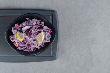 Purple cabbage and onion salad with various ingredients in ceramic cups